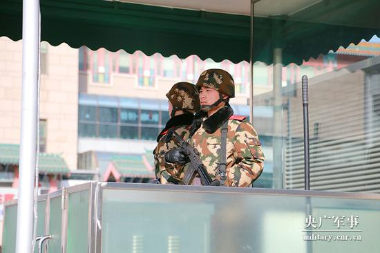 春运首日，两名武警官兵在北京西站南广场执勤。