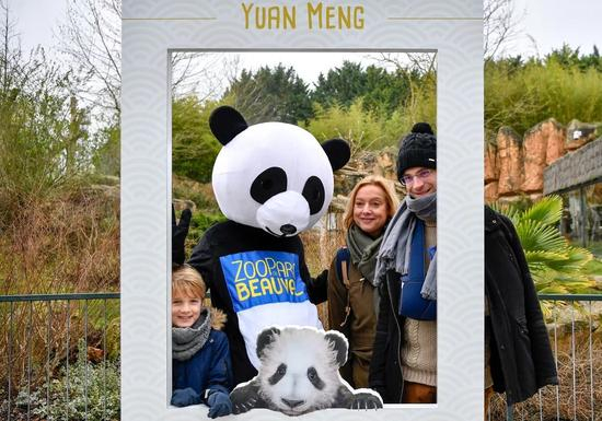 　　1月13日，在法国圣艾尼昂市博瓦勒野生动物园，游客与装扮成熊猫的工作人员合影。（新华社记者陈益宸摄）