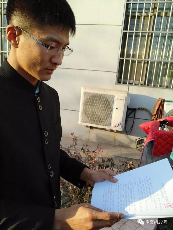 ▲朱振彪在核对判决书。新京报记者许研敏摄