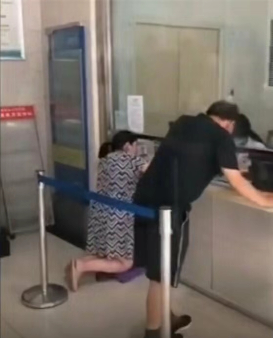 网传一孕妇在济源市人民医院就诊期间需跪着缴费。&nbsp; 网传视频截图