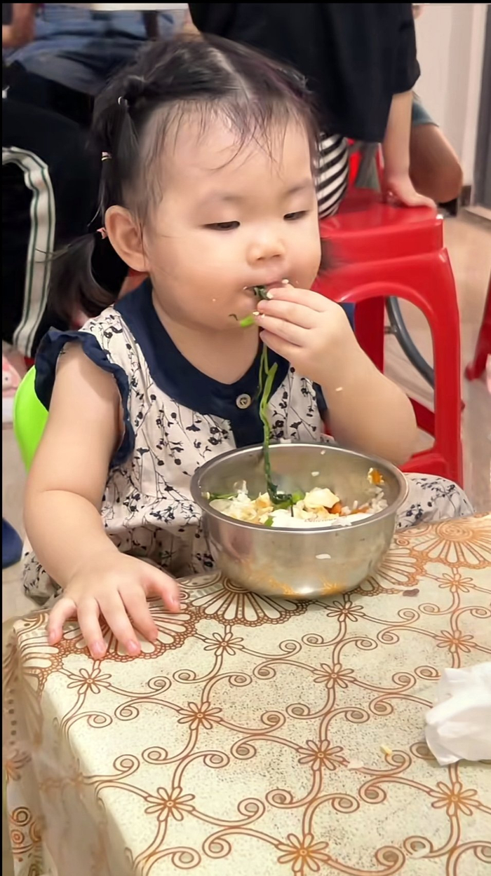小女孩吃饭很猛嫌勺子不过瘾直接上手