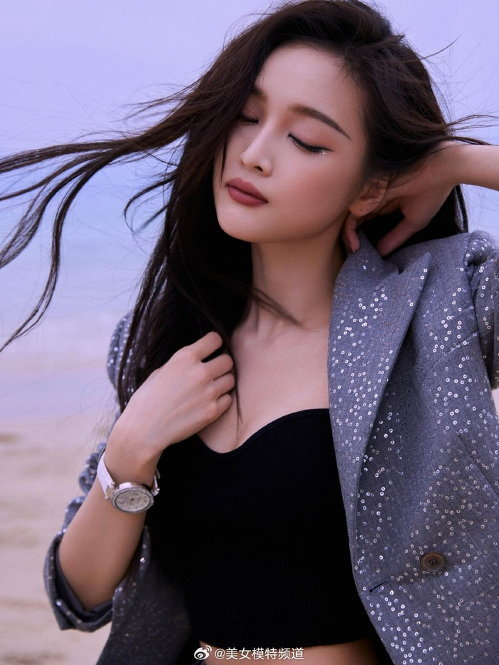 吴宣仪海边沙滩写真释出眼妆靓丽吸睛长发随风舞动