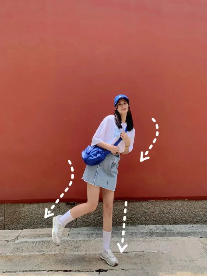 6,双手环抱弯下腿双手环抱,交叉弯腿很适合酷女孩拍,让腿顶出一个弧度