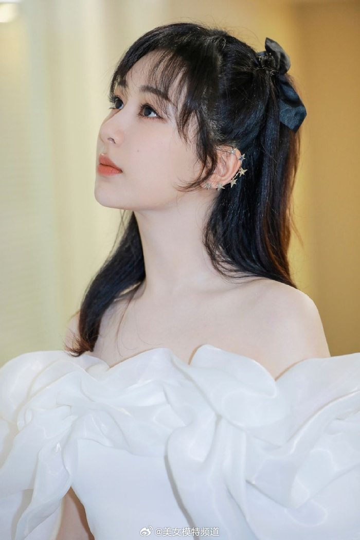 杨紫白色花瓣裙秀一字肩卷发搭蝴蝶结发饰清纯甜美
