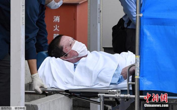 资料图：当地时间2020年5月27日，在日本京都市，日本警方以涉嫌谋杀、纵火等罪名正式逮捕青叶真司。图为青叶真司躺在担架上，被送往伏见区警署。