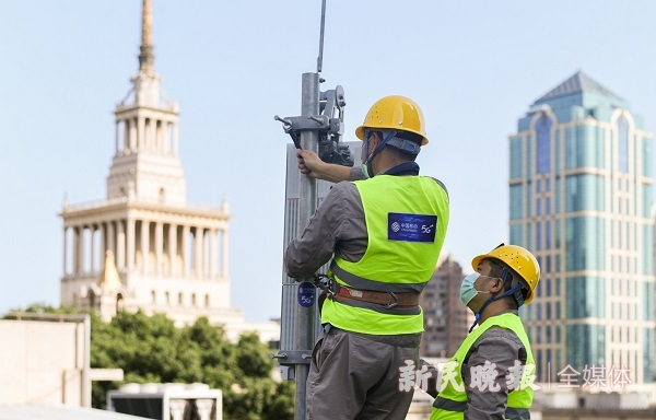 图说：上海移动的基站巡检人员正在对5G基站进行例行检查