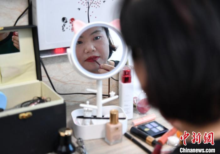 陈前芳说，减肥后她有很大改变，从来不爱照镜子的她，现在每天出门前都会化妆，让自己变得美美的。　张瑶 摄