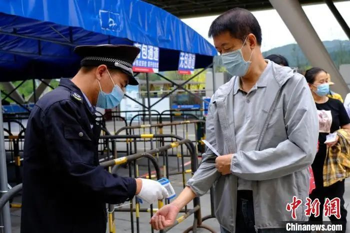 图为游客进入“中国天眼”天文科普基地时测量体温。　田举 摄