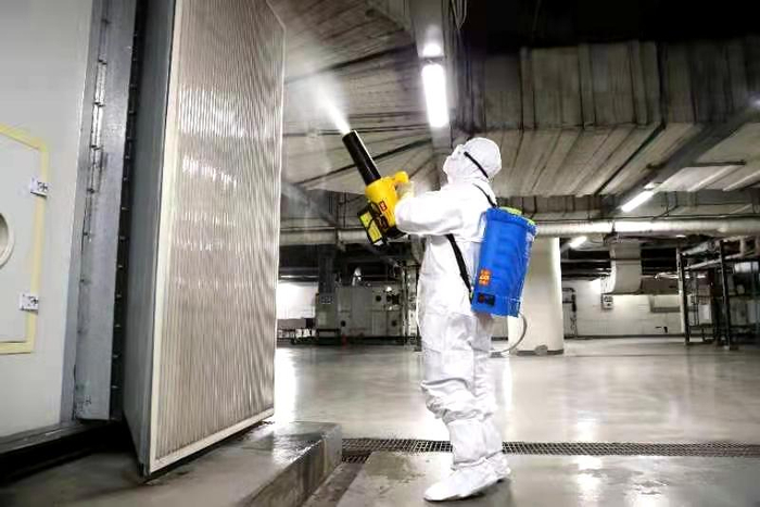 暖通空调系统运行员正在空调机房进行疫情防控消杀作业。摄影/通讯员 刘文倩