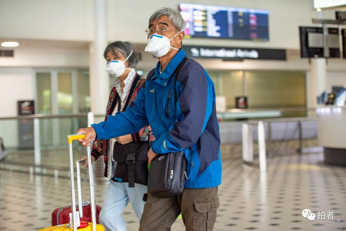 △ 当地时间3月25日，澳大利亚布里斯班国际机场，戴口罩的夫妇。