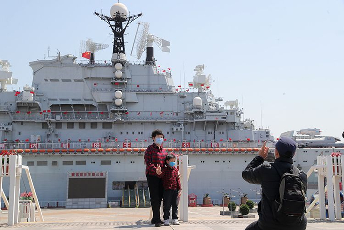 游客在“基辅号”航母前拍照。