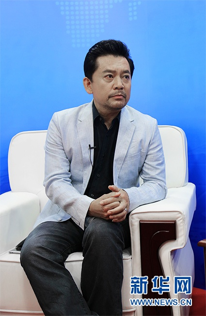 何政军在“5·10中国品牌日消费节”接受采访。新华网 韩攀 摄
