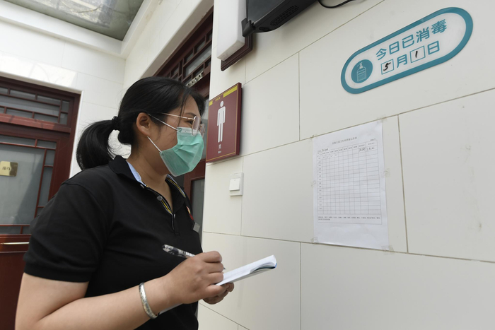 北海公园“美容师”张亚男在记录公共卫生间消杀情况。新京报记者 吴宁 摄