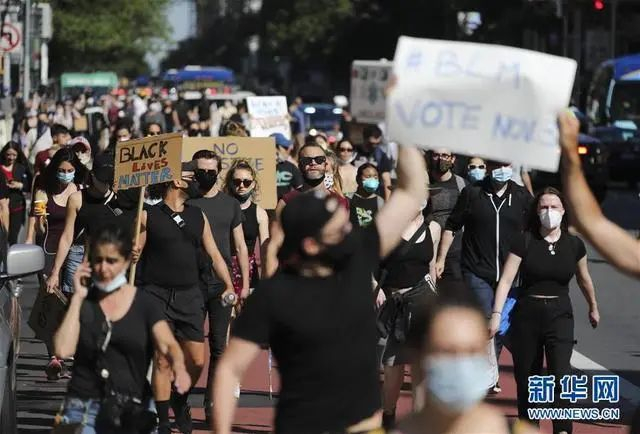 资料图。6月3日，人们手举标语牌在美国纽约街头抗议 图据新华社