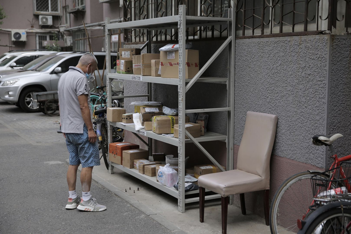 海淀区海淀南路北社区，小区今日禁止快递员进入，快递被寄放在小区入口处的快递架上。新京报记者 郑新洽 摄