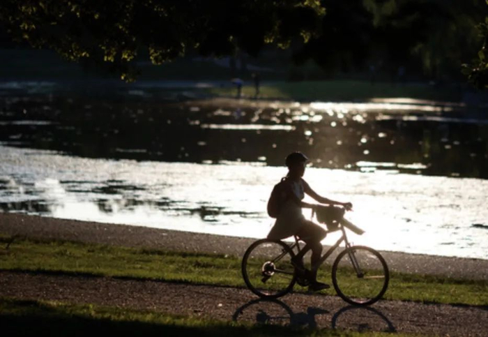 ▲6月21日，一名女子在美国首都华盛顿的国家广场骑车。 新华社发（沈霆 摄）