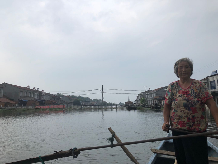 7月12日，李红芳（化名）等200名老人、小孩被转移安置到镇小，李红芳时不时回村，看看洪水是不是退了。