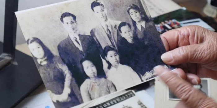 △江敏慈老人和初中老师、同学的合影，照片中她穿着白衬衫。