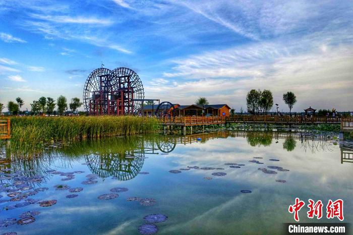 由沉沙池池区改造而成的位山湿地公园，岸边绿树成荫，木栈道在河中央蜿蜒盘踞着，水车吱吱呀呀的工作，耳边不时响起几声清脆的鸟叫声。　孙婷婷 摄