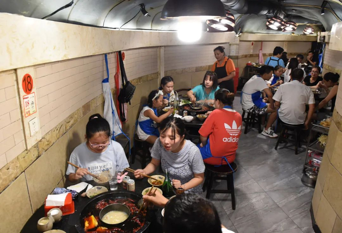 △重庆高温天气持续 民众防空洞内纳凉吃火锅。周毅 摄