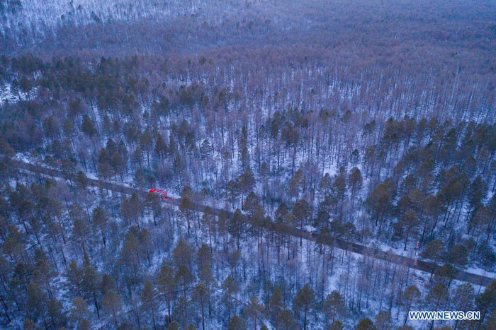 Aerial photo shows a fire engine patrolling on a road in Beiji Village of Mohe City, northeast China's Heilongjiang Province, Jan. 13, 2021. Firefighters stick to their post and keep training despite the freezing weather in Mohe, the northernmost city in China, where the temperature is often below minus 40 degrees Celsius in winter. (Xinhua/Xie Jianfei)