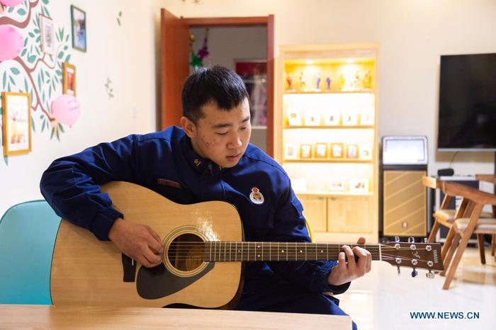Firefighter Wu Junming plays the guitar in the activity room of the fire station in Beiji Village of Mohe City, northeast China's Heilongjiang Province, Jan. 13, 2021. Firefighters stick to their post and keep training despite the freezing weather in Mohe, the northernmost city in China, where the temperature is often below minus 40 degrees Celsius in winter. (Xinhua/Xie Jianfei)