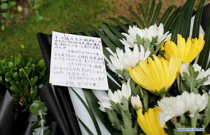 Flowers are placed by citizens to pay homage to deceased China's top hepatobiliary surgeon Wu Mengchao at the Longhua funeral parlor in east China's Shanghai, May 26, 2021. A memorial service for Wu Mengchao, known as the 
