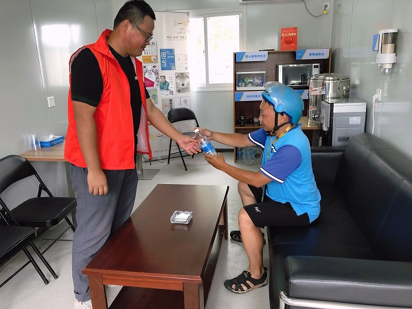 图说：项目职工志愿者正热情招呼一名快递小哥