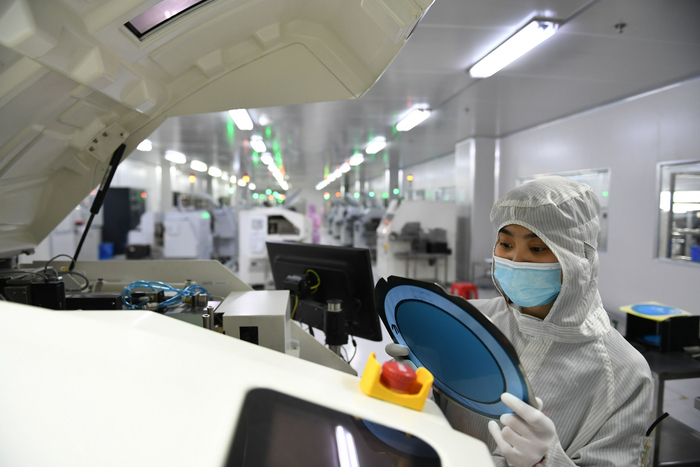 　　2021年4月24日，安徽省马鞍山市，在位于马鞍山经开区的安徽省东科半导体有限公司生产线上，工人正在生产芯片。图/IC photo