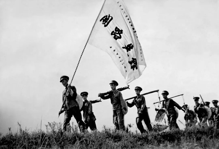 ▲筑路军工扛着开路先锋大旗奔赴筑路一线。