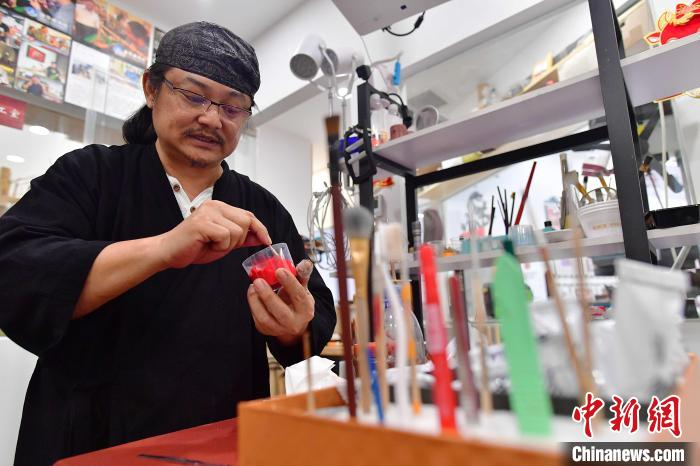 图为黄守堃正在调制上漆用的原料。　张斌 摄