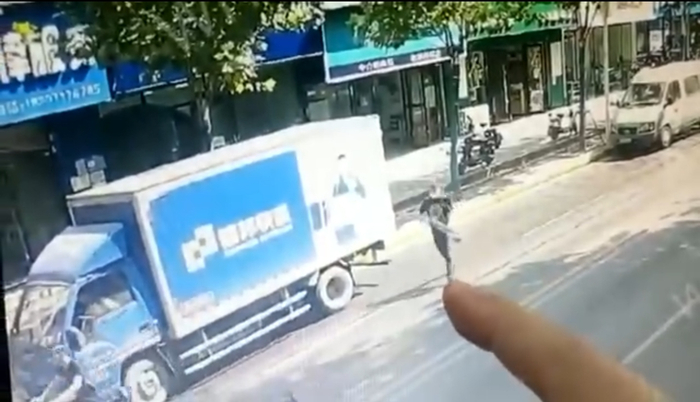 监控画面显示，一黑衣男子拿着网球拍套从法律维权服务中心走出。视频截图