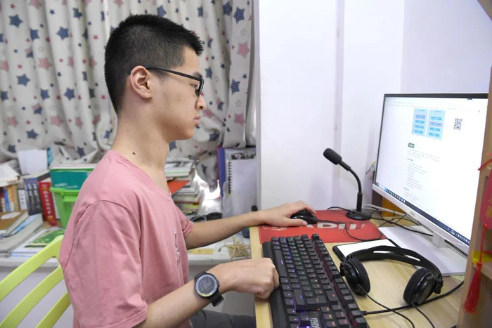 郑宇宸在广西河池市金城江区自己家里用左手上网（8月18日摄）。新华每日电讯记者周华摄