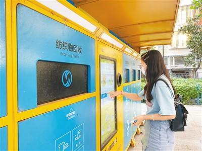 北京市朝阳区一小区内，居民正在向回收箱投递可回收物品。徐俊奕摄