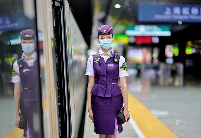 乘务人员在车门口迎接旅客上车。&nbsp; 周围 摄