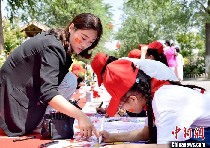 在古黄河畔鲤鱼山庄景区，王集小学师生共同绘制百米儿童画长卷。　朱志庚 摄
