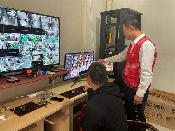 北海移动工作人员与物业公司工作人员使用移动“AI电梯阻车系统”进行监控（央广网发 中国移动通信集团广西有限公司供图）