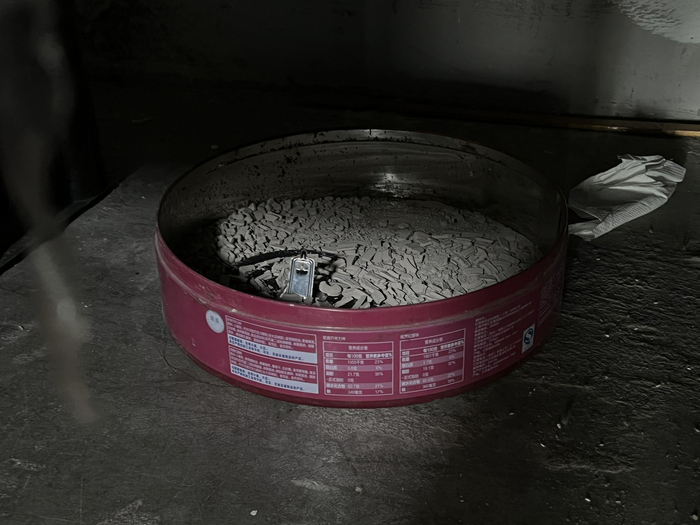 万永贵的简易床下塞着一个铁盒，用来盛放蚊香，盒内已积满香灰。新京报记者 杨雪 摄&nbsp;