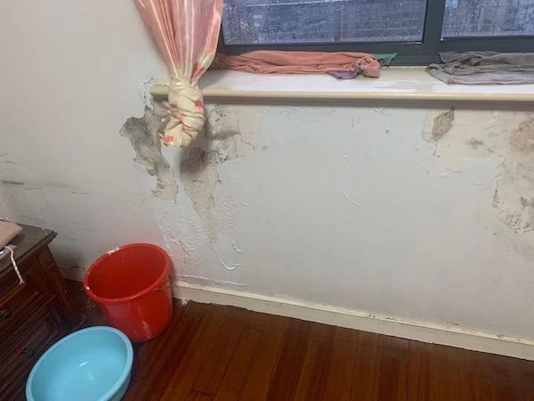 图说：有的业主家中渗漏严重，一下大雨，卧室和阳台就漏水