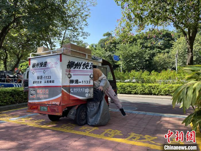 快递员将车辆停放在人行道“专属”车位上。　林馨 摄