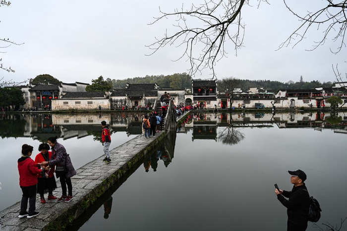 3月18日，游客在黄山市黟县宏村风景区画桥游览。新华社记者 韩旭 摄