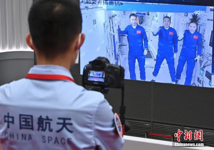 资料图：北京航天飞行控制中心屏幕显示航天员乘组报告进入天和核心舱的画面。 中新社记者 侯宇 摄