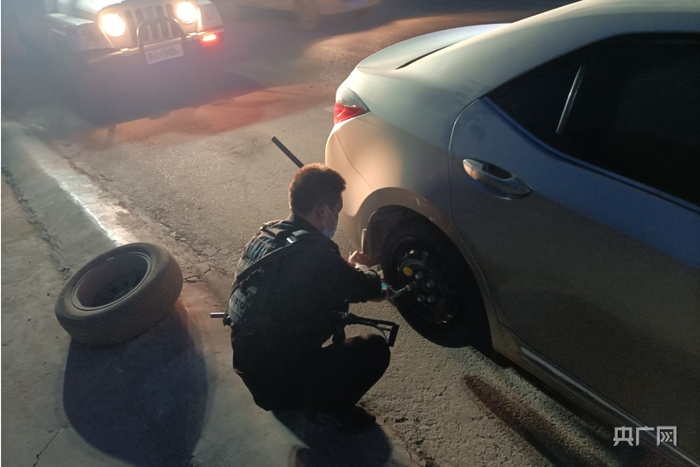 佳木派出所便民警务站执勤民警帮助群众更换备胎。央广网发