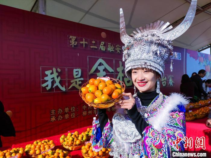 一位苗族姑娘在展示融安金桔。　覃唯益 摄