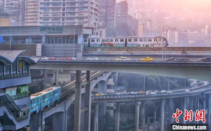 图为重庆轨道交通2号线与3号线换乘站牛角沱站，两条线路的列车交错行进在上下车流中。　陈秋杏 摄