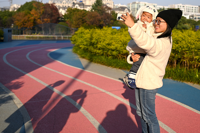 2021年12月3日，苏州河中环立交桥段，陈洁抱着她儿子在河边跑道上自拍。