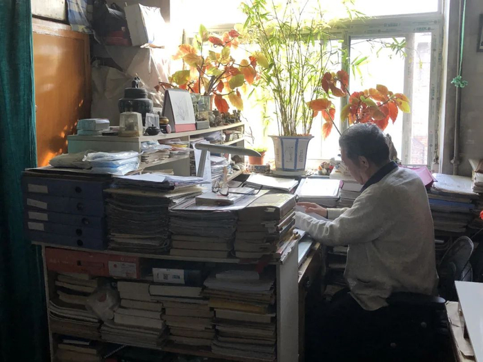 ▲张军收集的案件材料有一大摞，每份材料他都仔细看过。王翀鹏程摄