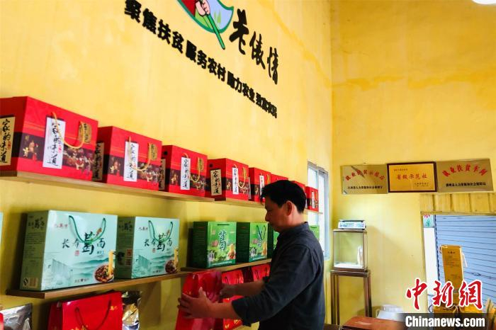 图为在江西横峰县葛源镇清湖村电商服务站，周小华整理货物。　吴鹏泉 摄