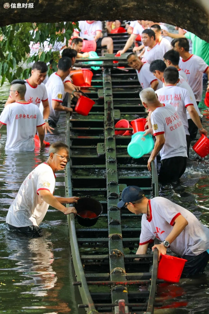 村民们为刚刚“起”出来的龙船做清洁。信息时报记者 陈文杰 摄