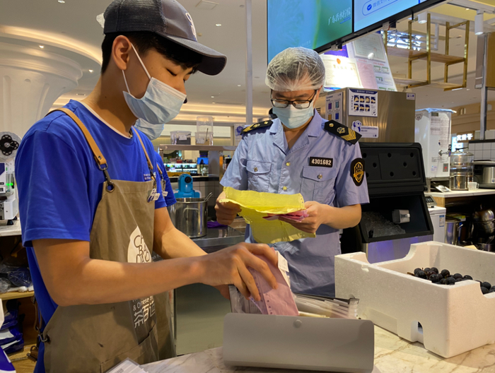 开福区市场监管局执法人员在茶百道（世纪金源店）检查原材料进货台账。长沙晚报全媒体记者 周辉霞 摄